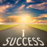 37044079 - driving on an empty asphalt road towards the setting sun and sign which symbolizing success. concept for success.